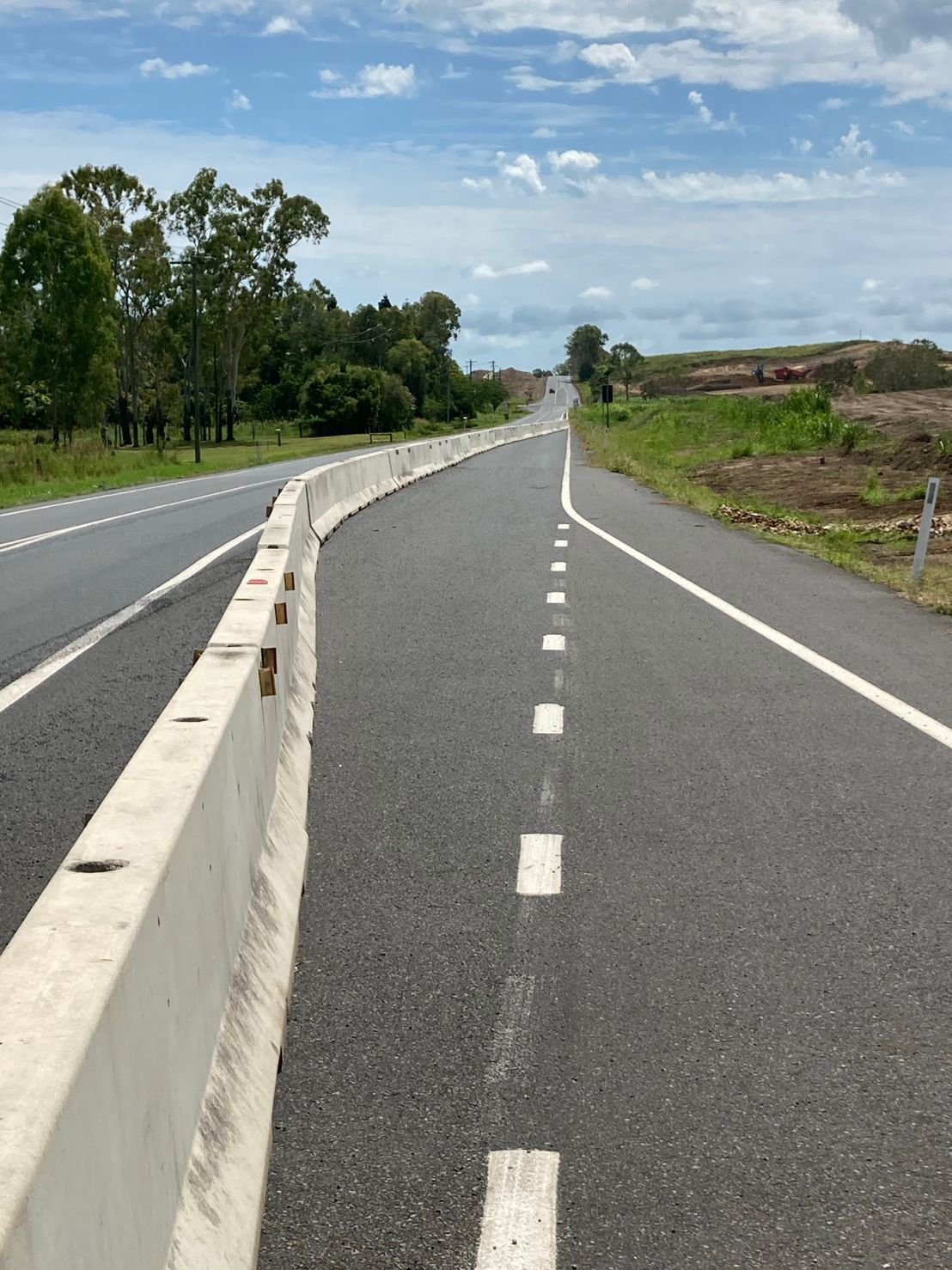 Concrete traffic barrier installation along a North Queensland highway