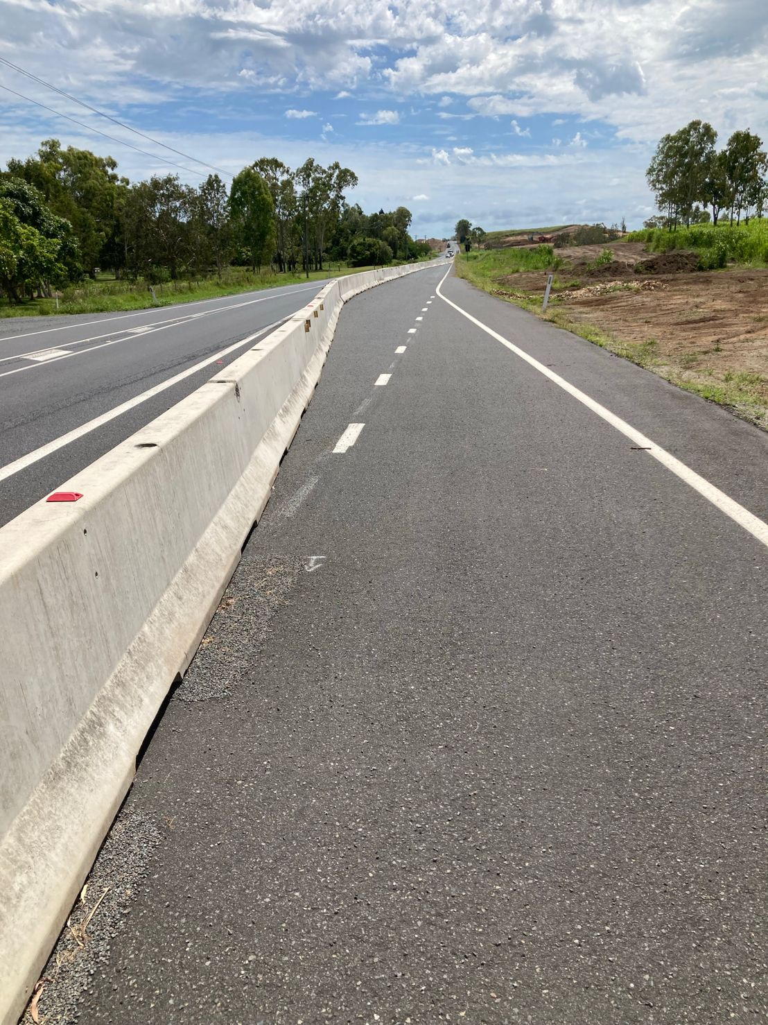 Concrete barrier line separating traffic lanes on a regional road